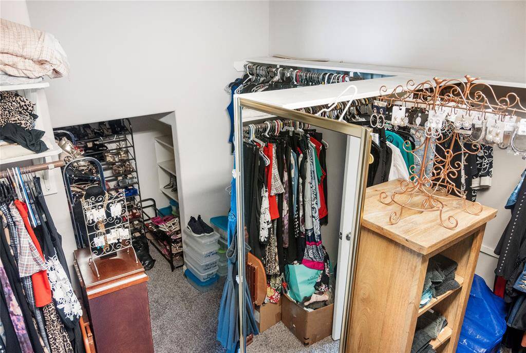 A clothing lover’s dream—this expansive primary closet features custom shelving, a dedicated shoe nook, and space to spare