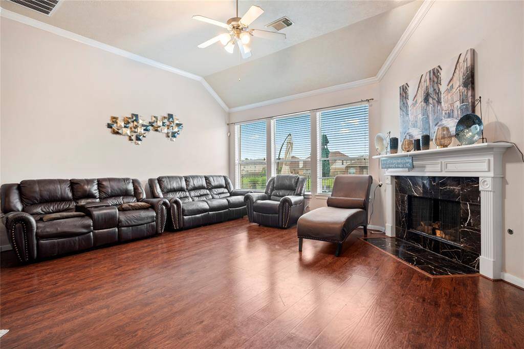 this spacious living room features windows that frame uninterrupted views of the waterfront, flooding the space with natural light and creating a calm, airy atmosphere.