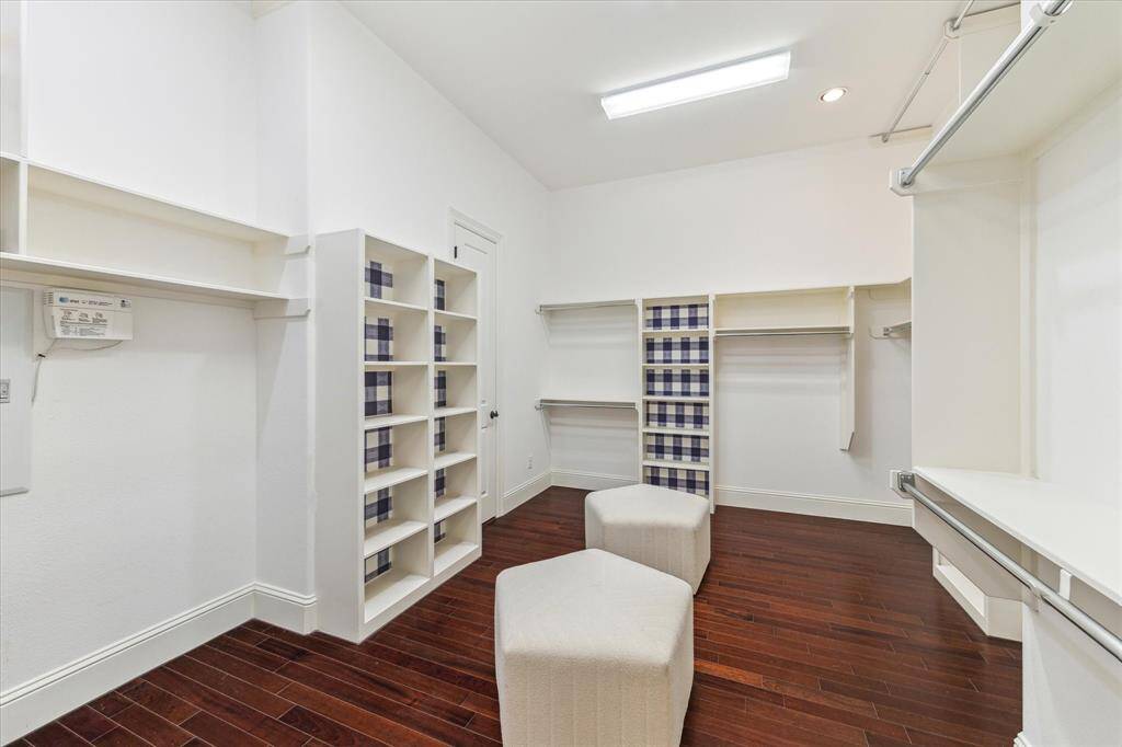 This huge primary closet offers both convenience and functionality with direct access to the laundry room. Thoughtfully designed for optimal organization, it presents the ideal opportunity to add a custom closet island with drawers.