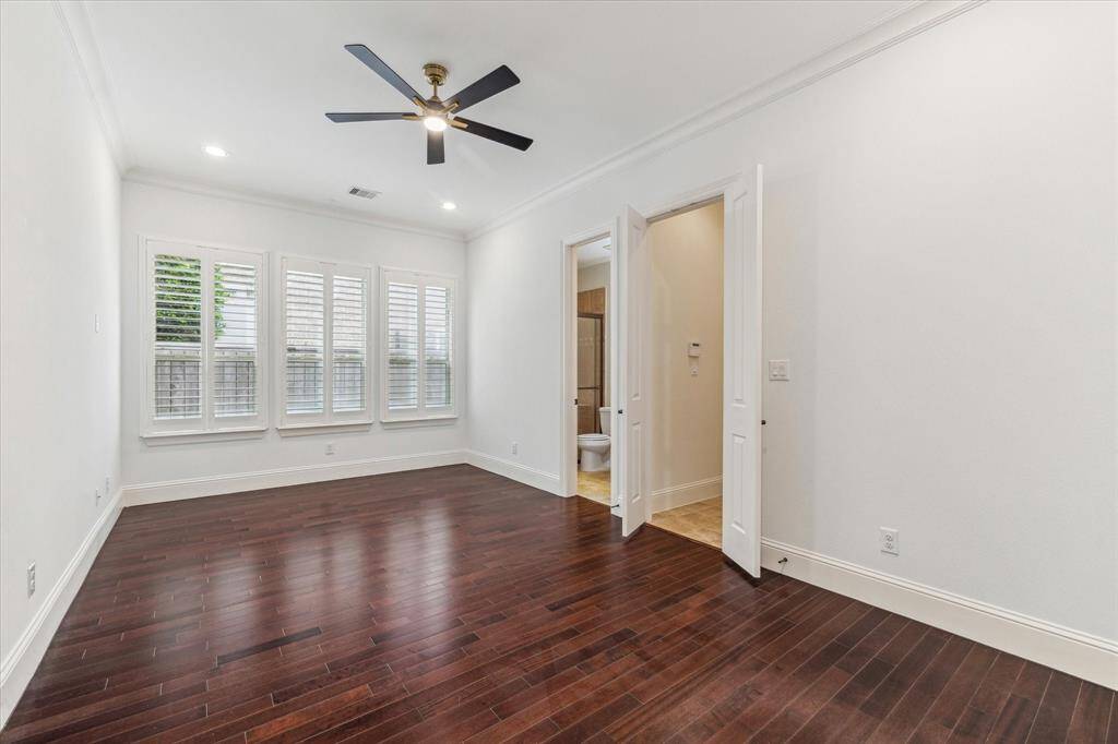 Bedrom 2 - This room offers a direct access hallway to the 1 car garage. Multi-gen opportunity with this space. Bedroom includes a private ensuite, wood flooring, new ceiling fan, shutters and neutral paint.
