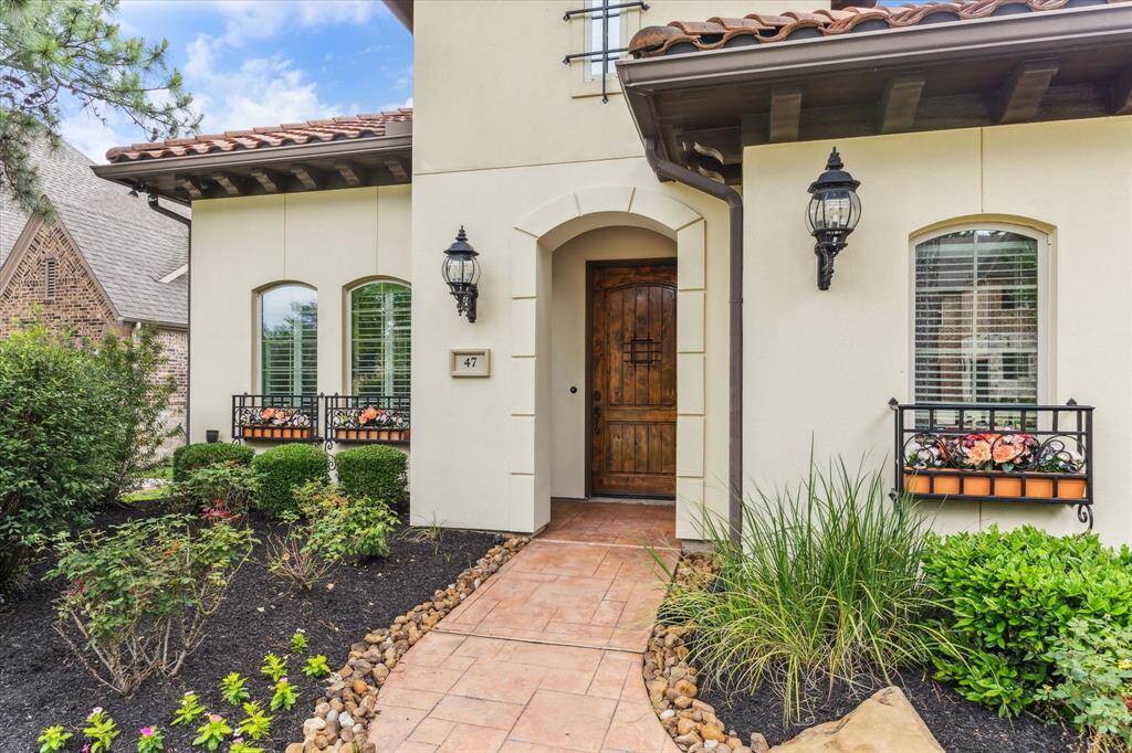 An 8' solid wood front door with peekabo window welcomes guests.