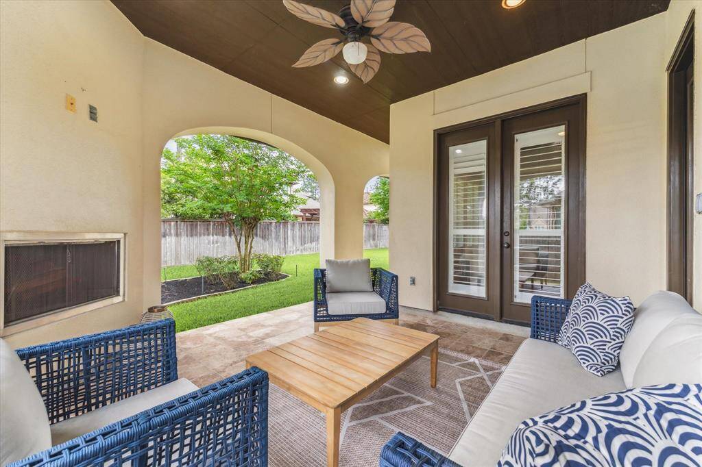 Unwind in style year-round on the covered patio, complete with a cozy fireplace.