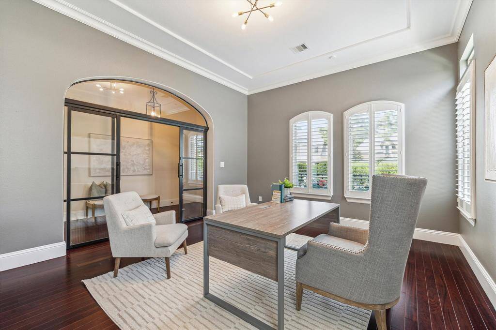 Modern iron and glass sliding doors were added to the home office for privacy, adding a dramatic statement wall.