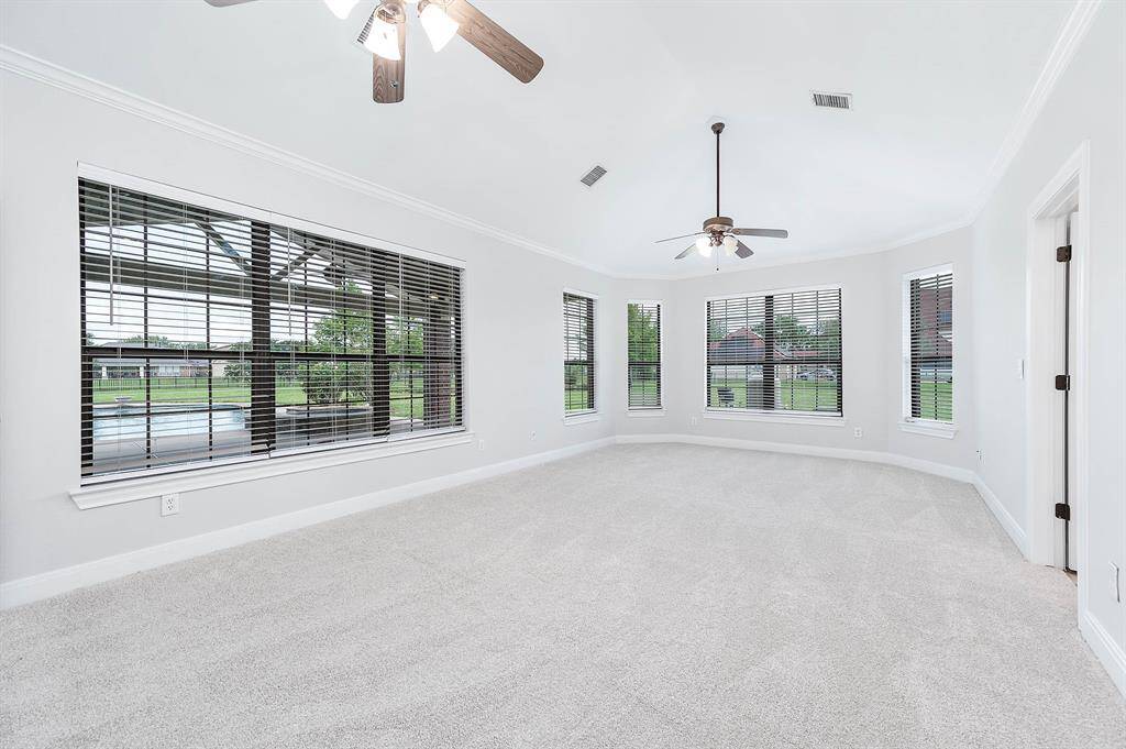 Oversized master bedroom with view of pool and pond