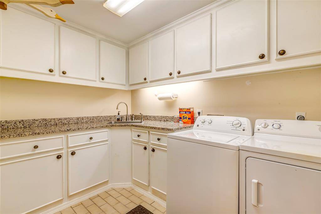 Large laundry room with built in cabinets and sink