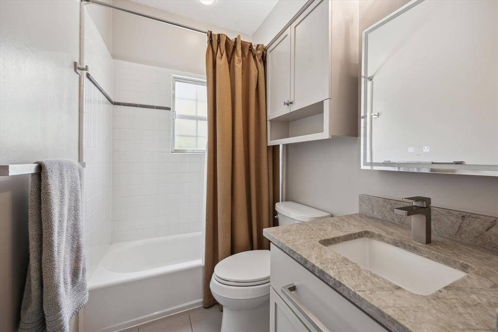 Another full bath on the 2nd floor featuring new countertops, sink and toilet.