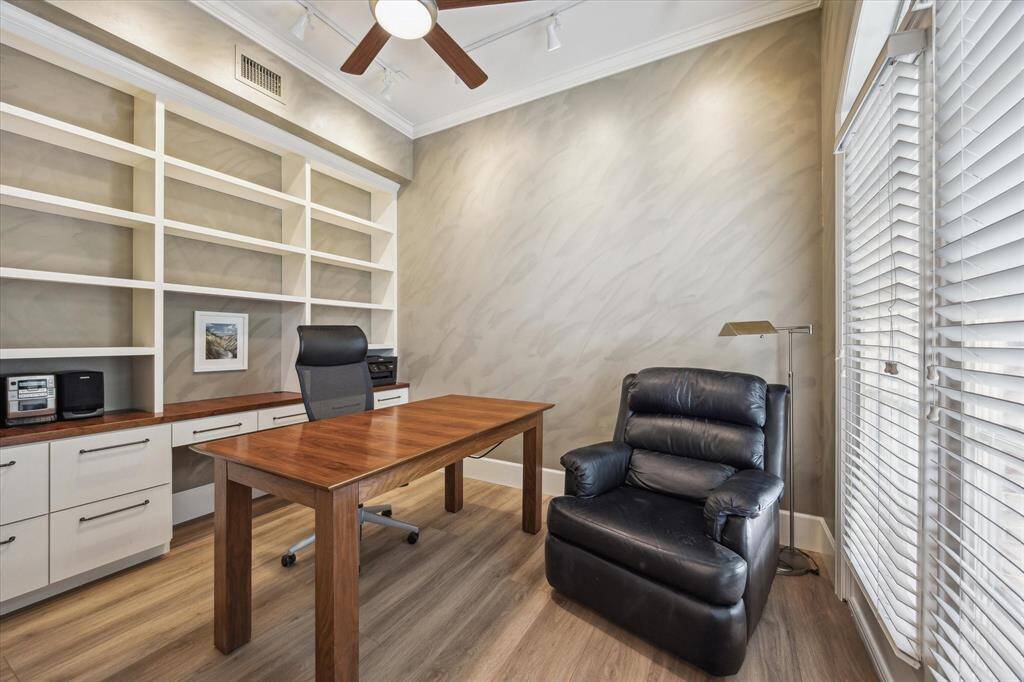 Office/study with aan abundance of natural light. Built in bookcase with file cabinet drawers below.