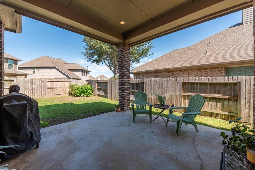 Great covered back porch and BBQ area!