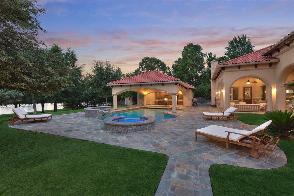 Gorgeous resort-style heated pool with underwater seating, a covered swim-up bar, and a heated spa for year-round relaxation.