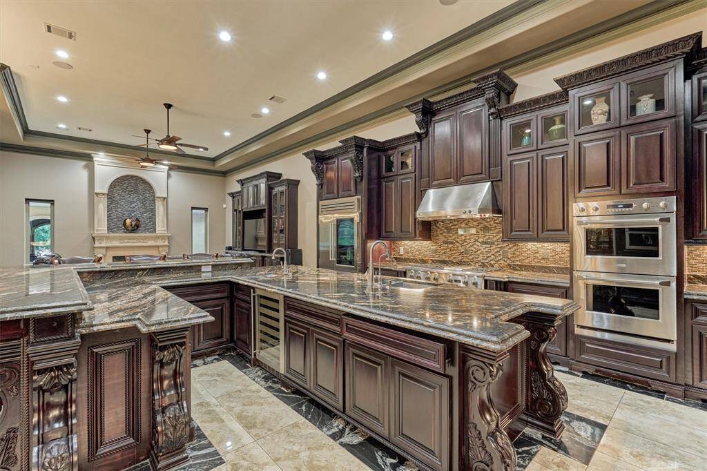 Prep and serve with ease—this kitchen includes a built-in wine cooler and custom cabinetry.