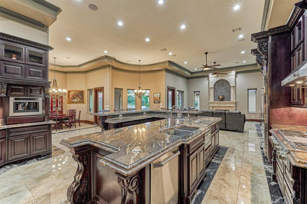 Massive U-shaped granite island with dual sinks and bar seating-perfect for entertaining.