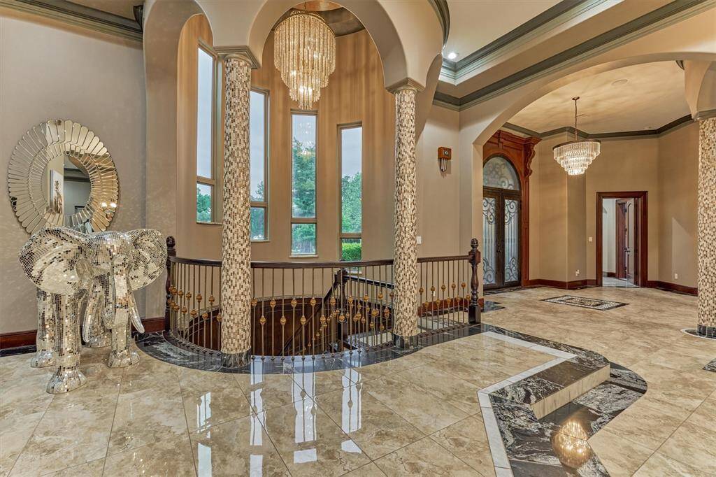 Dramatic staircase crowned with a custom-painted Italian ceiling mural.