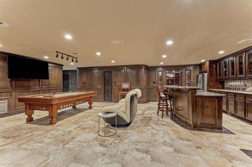 Game room includes a full kitchen for snacks, drinks, and seamless hosting.