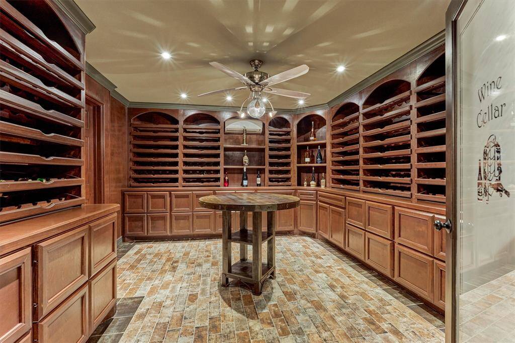Stone-tile accented wine grotto tucked behind the lower-level kitchen—ideal for collectors and entertainers.