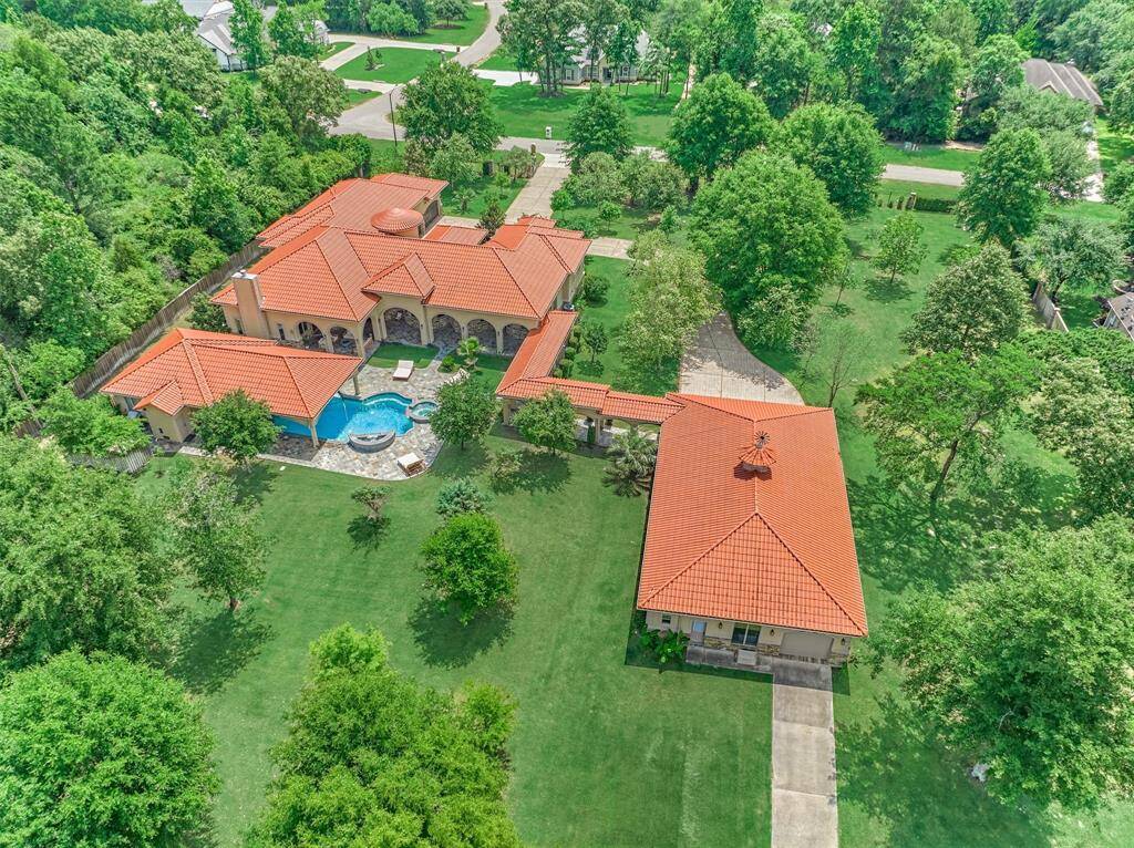 Sprawling 2-acre estate with fruit trees, mature landscaping, and serene lakefront views.