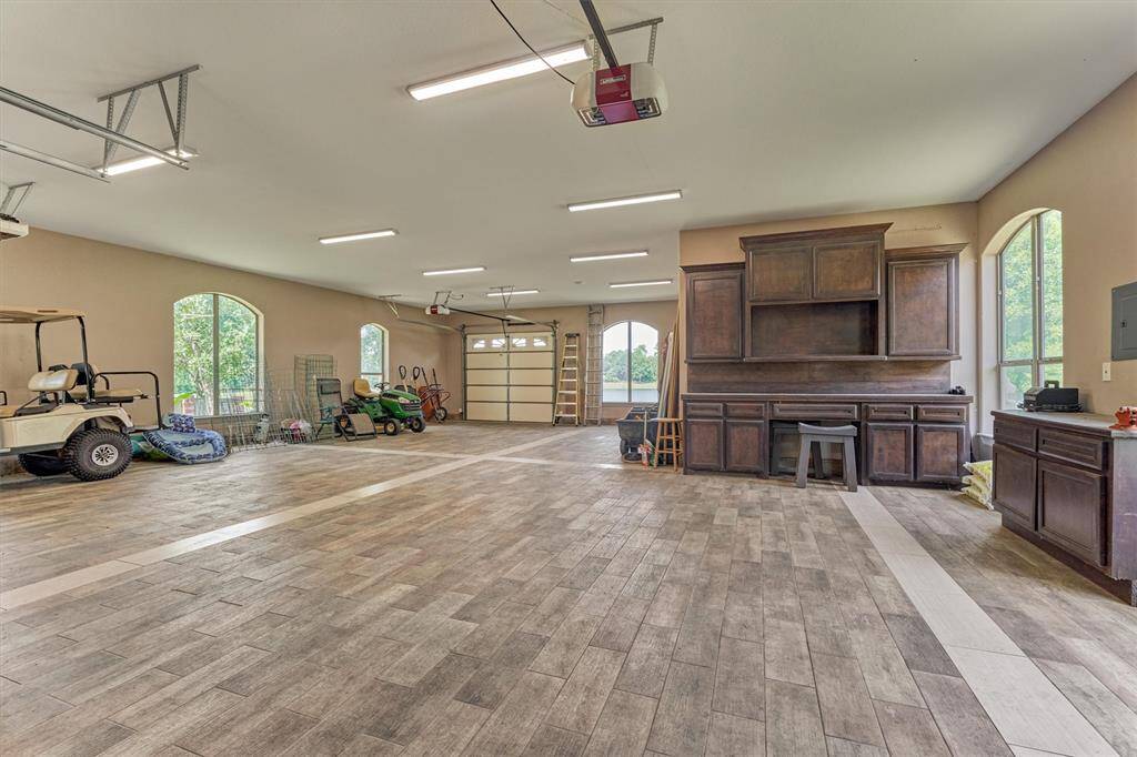 This is one of the two 4-car garages with tile flooring and a dedicated bathroom—room for cars and more.