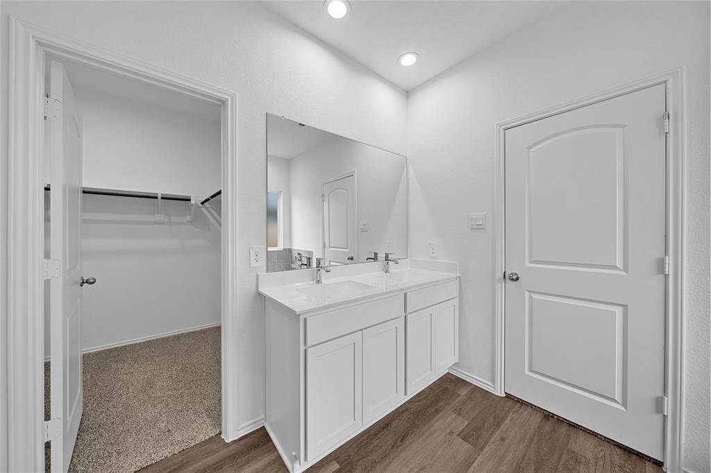 Primary bathroom with view of the closet