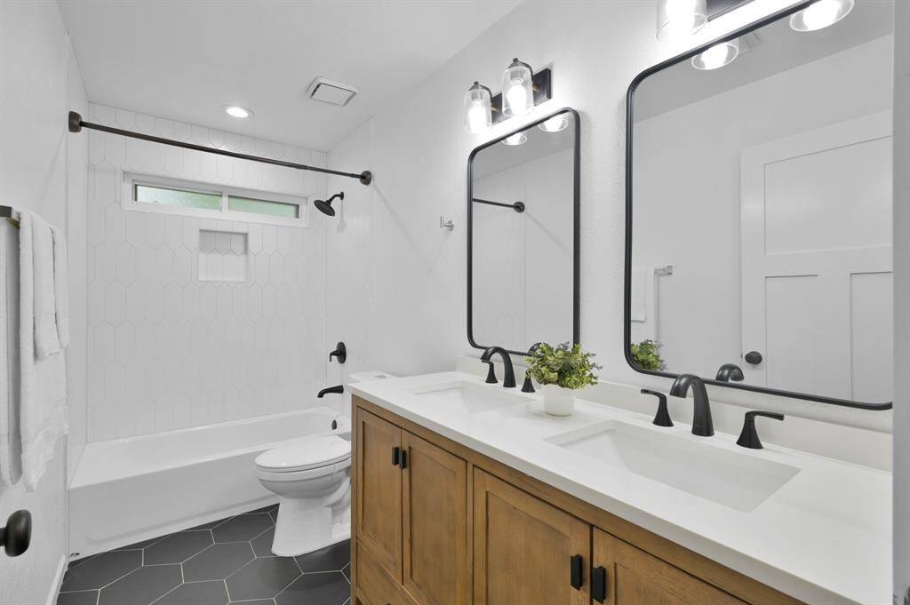 Newly renovated secondary bathroom with a dual sinks for convenience.