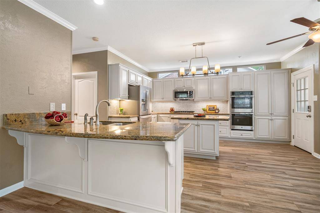 The family living area is open to the kitchen breakfast area.  A a few bar stools and enjoy the remodeled kitchen.