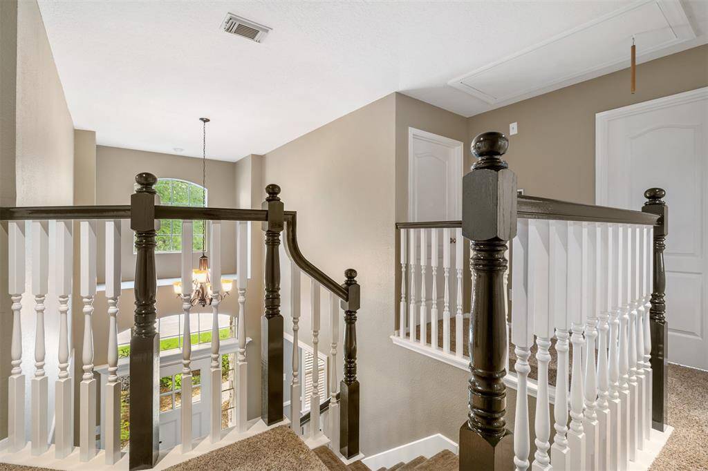 High ceilings, attractive staircase leading to the bedrooms upstairs.