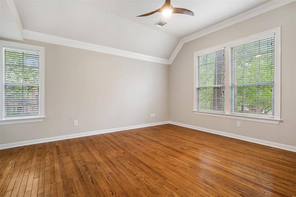 The primary bedroom has lovely hardwood floors, lots of natural lighting, remote control ceiling fan and a fabulous, updated bathroom.  The floors are reclaimed wood and beautiful.