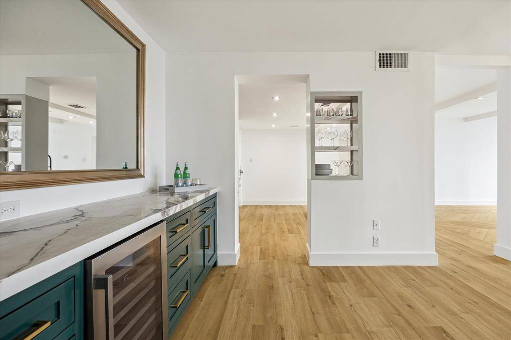 Dining with custom cabinetry and wine cooler