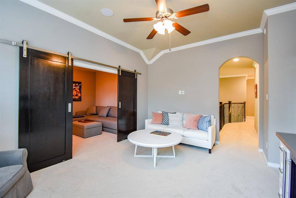 Barn-doored media room & beverage fridge upstairs in game room!