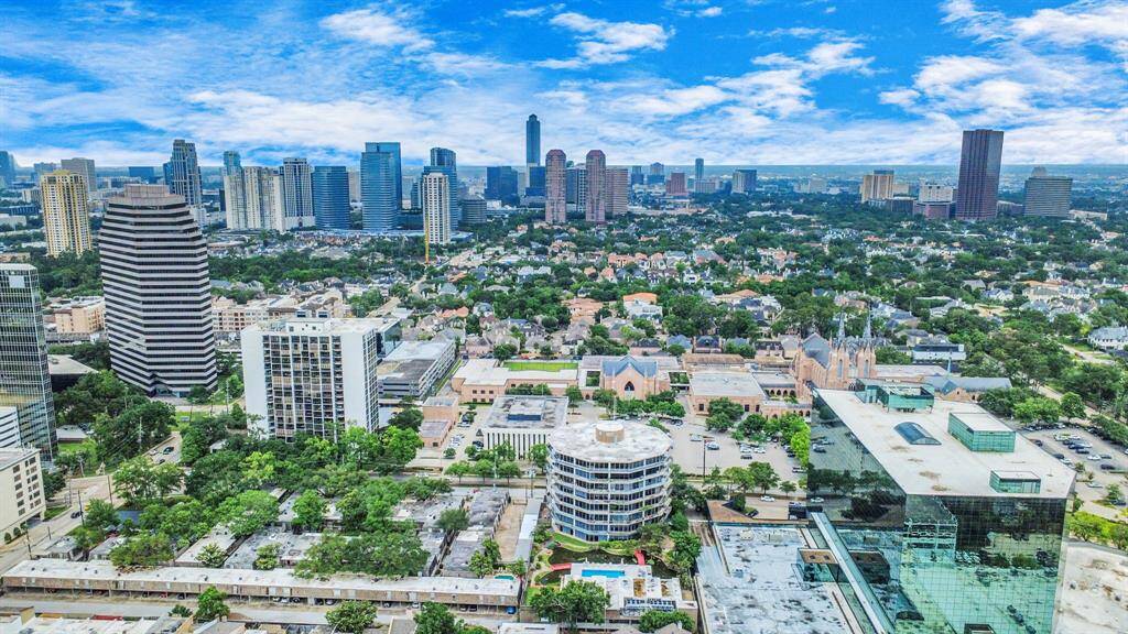 This VIEW! A vibrant urban landscape with a mix of modern skyscrapers and lush greenery, offering potential home buyers a view of the Galleria!