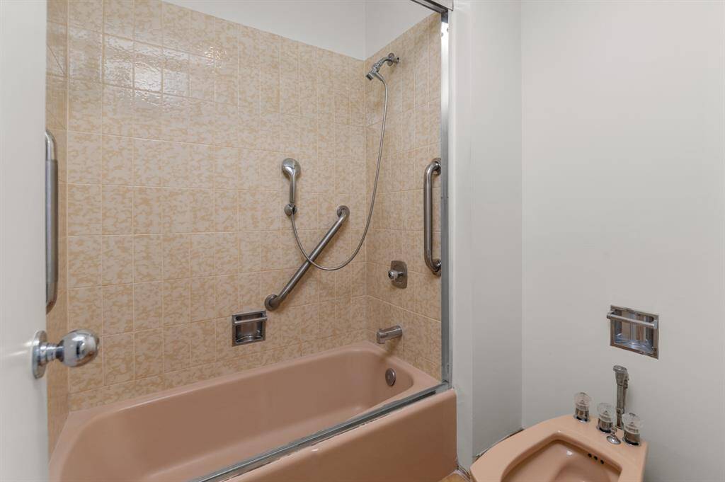 This modern shared public area features a cozy seating arrangement with a sleek fireplace, stylish furniture, and large windows that allow for ample natural light. Ideal for relaxation and entertaining.