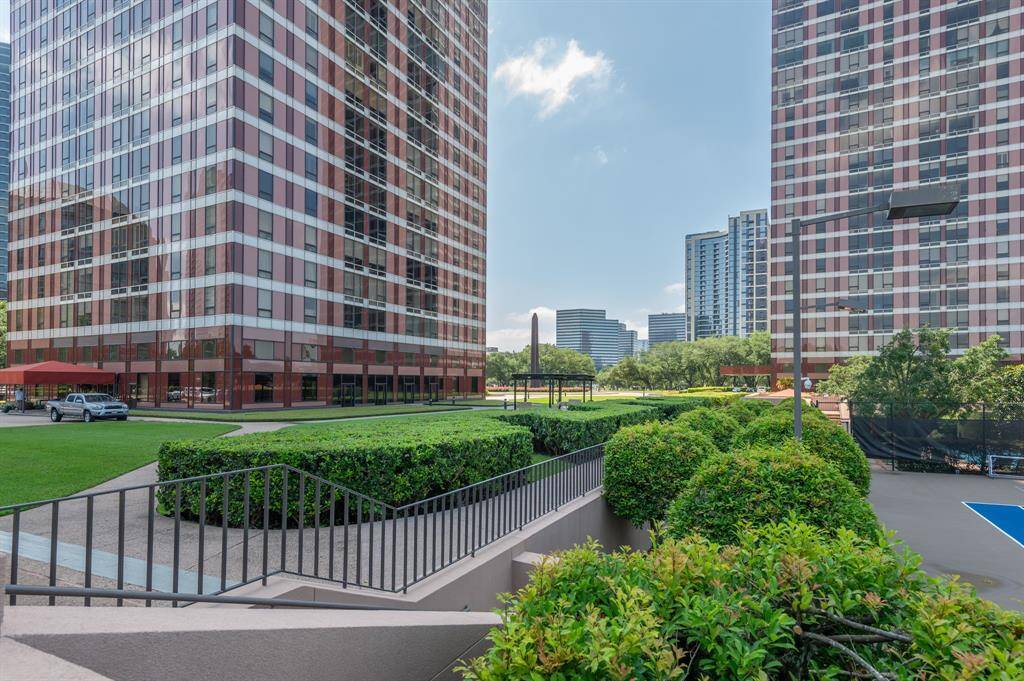 Modern high-rise buildings with a well-maintained courtyard featuring lush greenery. Ideal for urban living with nearby amenities and recreational spaces.