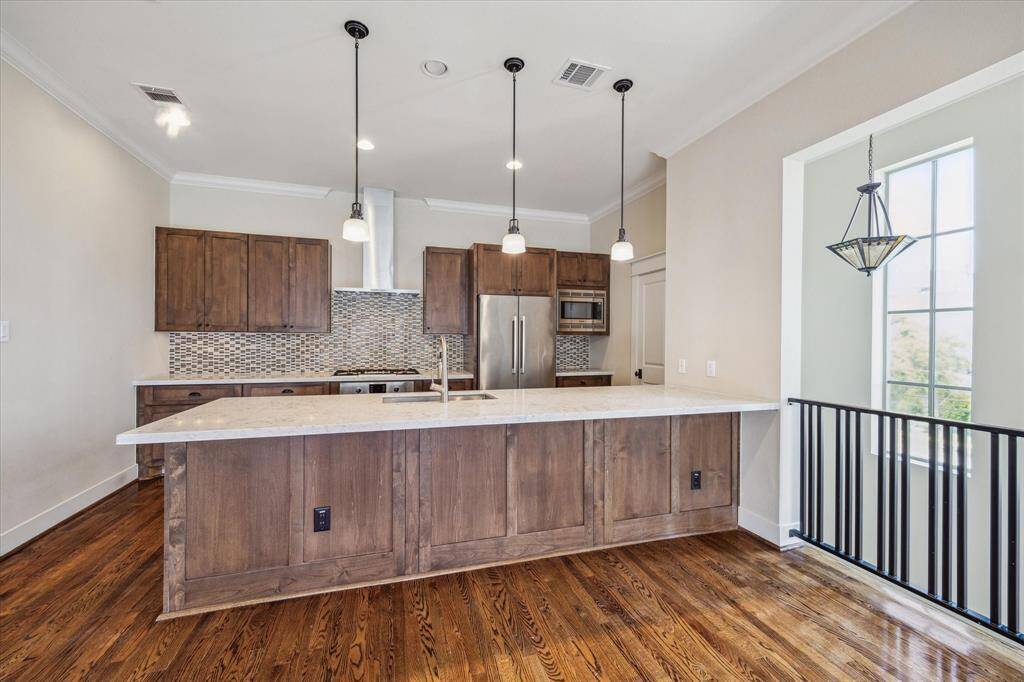 Another view of kitchen and bar. Open to stairs so great light in the room.