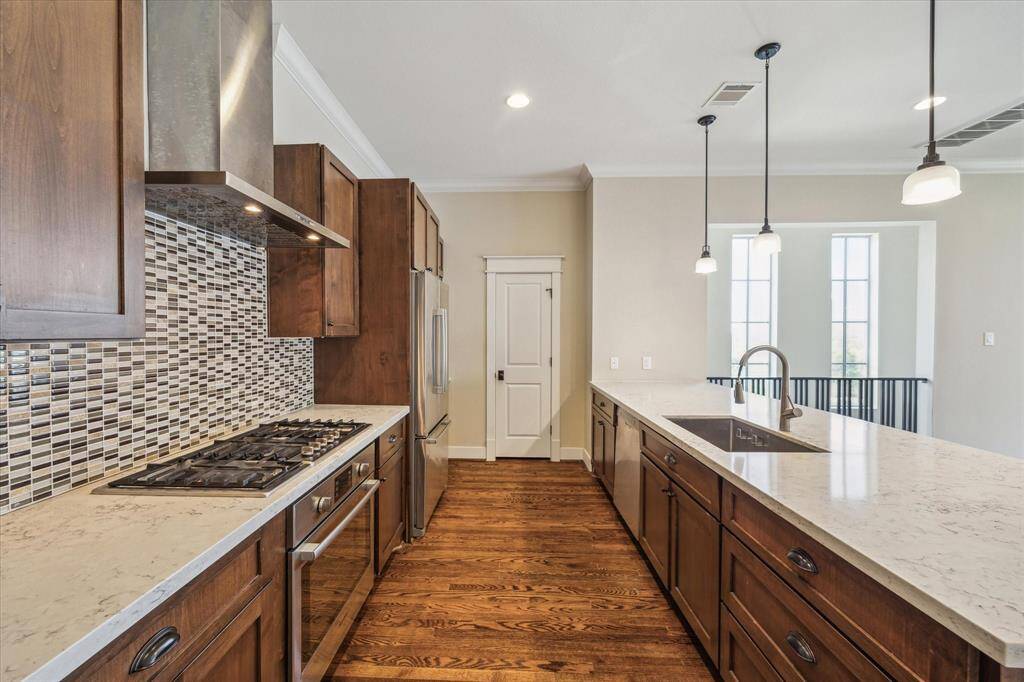 Kitchen with gas range and staineless appliances.