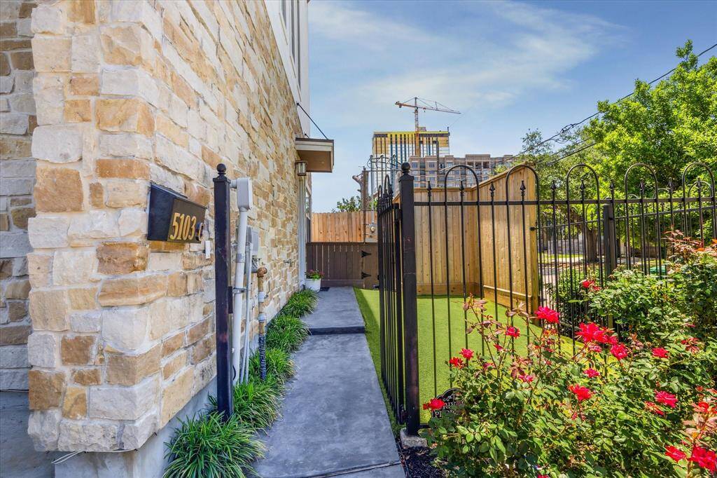 Turf front yard and stone accent as you enter the stamped concrete front path.