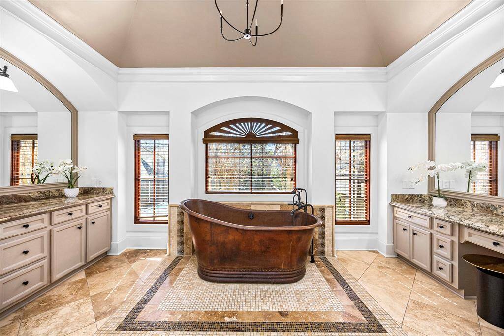 Soaking tub between his and hers vanities