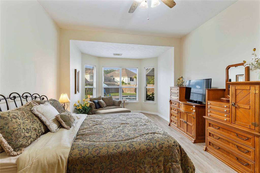 Enjoy your backyard pool view from your primary bedroom