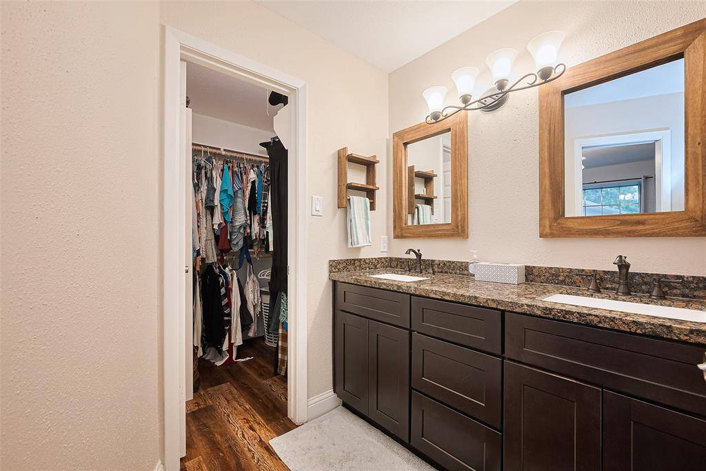 Double sinks in primary bathroom with walk in closet.