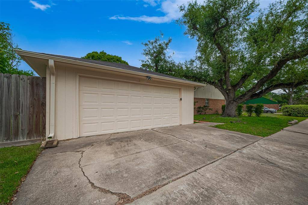 Extended two car garage with automatic opener and extra driveway parking.