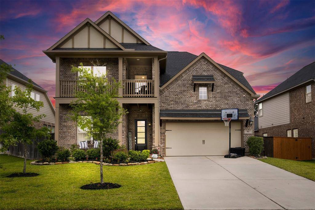 Stunning 2 story brick home with a welcoming front porch and balcony. The property features a well-maintained lawn and an oversized 3 car garage!