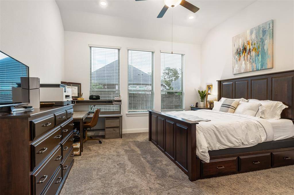 Gorgeous master suite on first floor offers lots of space and large windows into the backyard