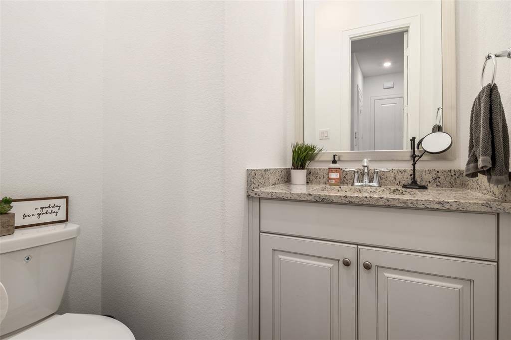 The half bath for guests right off the entry of the home on the first floor