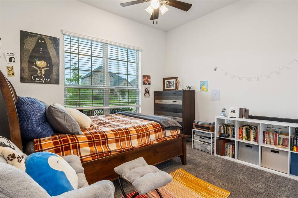 Cozy second bedroom downstairs at the front of the house with a full bathroom that includes a spacious shower and walk in closet!