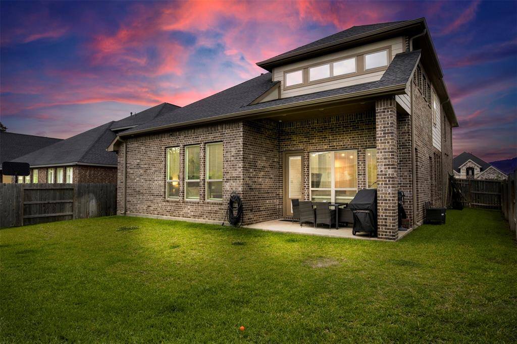 spacious backyard with lush green grass thats perfect for pets or play!