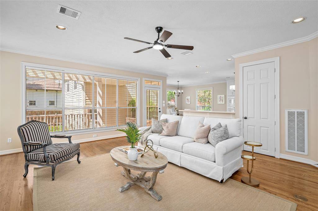 The wall of windows offers a great view of the backyard & elevated porch.  House & garage never flooded (per seller).