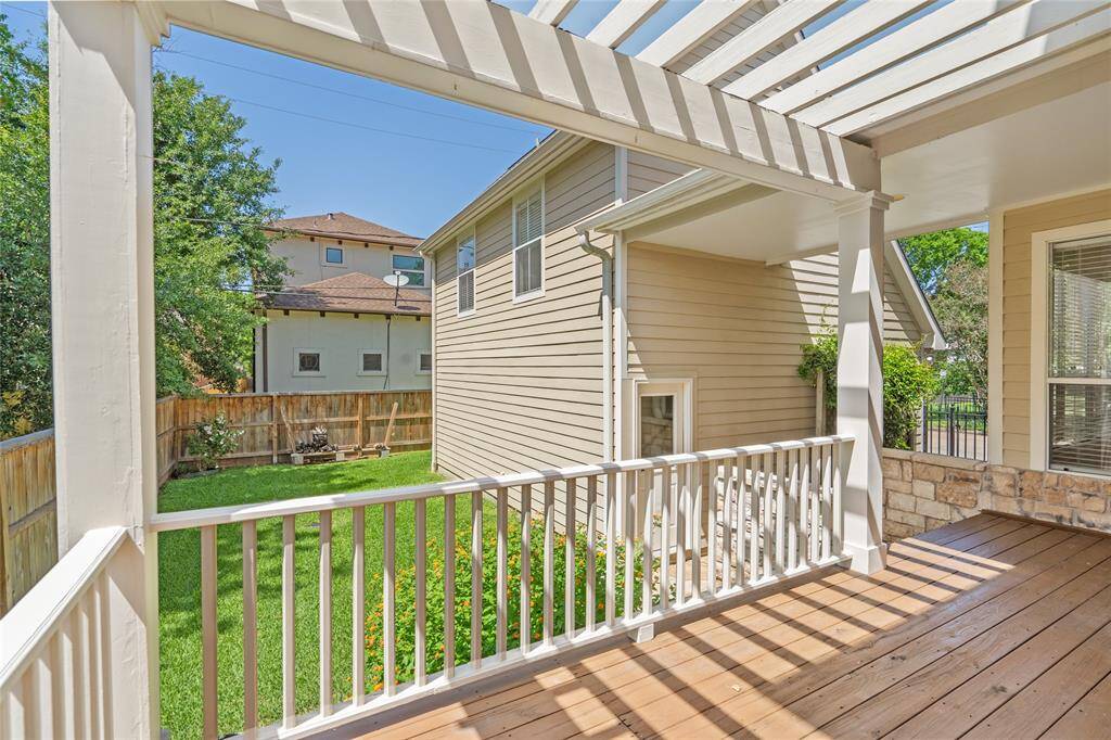 This private backyard offers plenty of grassy lawn for play.  It's both private and tucked securely behind pedestrian gate.