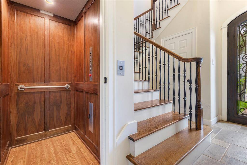 Elevator and staircase offer convenience and style for easy access throughout the home.