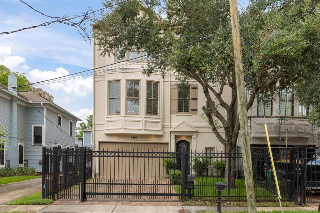 Discover your dream home at 5202 Jackson Street—a stunning, gated property featuring elegant architecture and a lush, private yard.