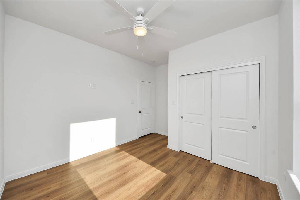 The third bedroom with a double door closet and natural lighting.