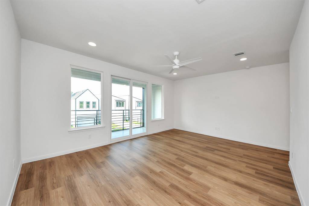 The main bedroom featuring double doors that opens to a private balcony, inviting natural light and fresh air.