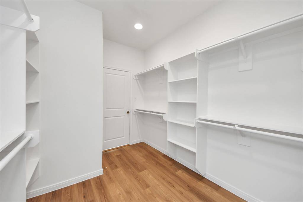 The main closet features a clean organized layout with sturdy shelves.