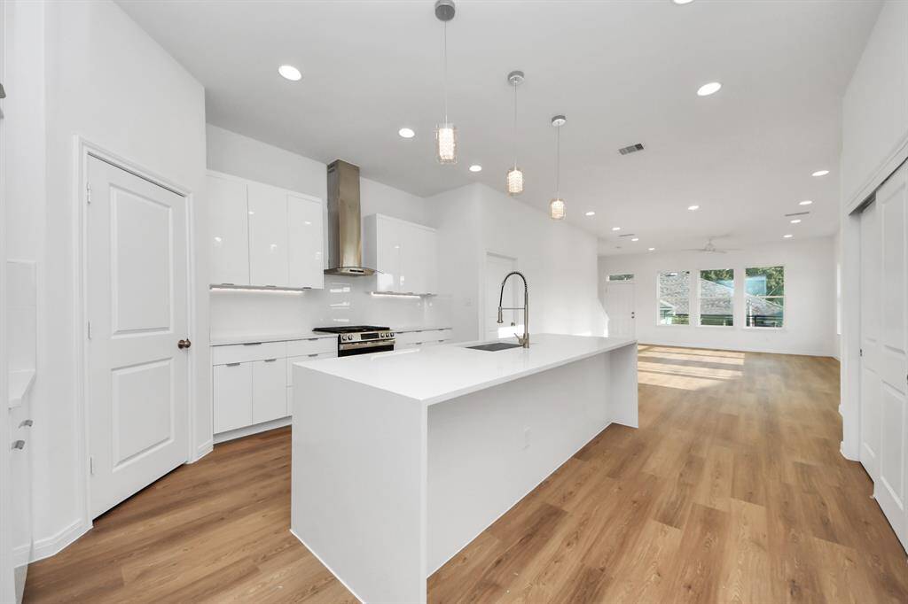 The kitchen island is stylish, featuring elegant Quartz countertops, soft opening cabinets and silver hardware.